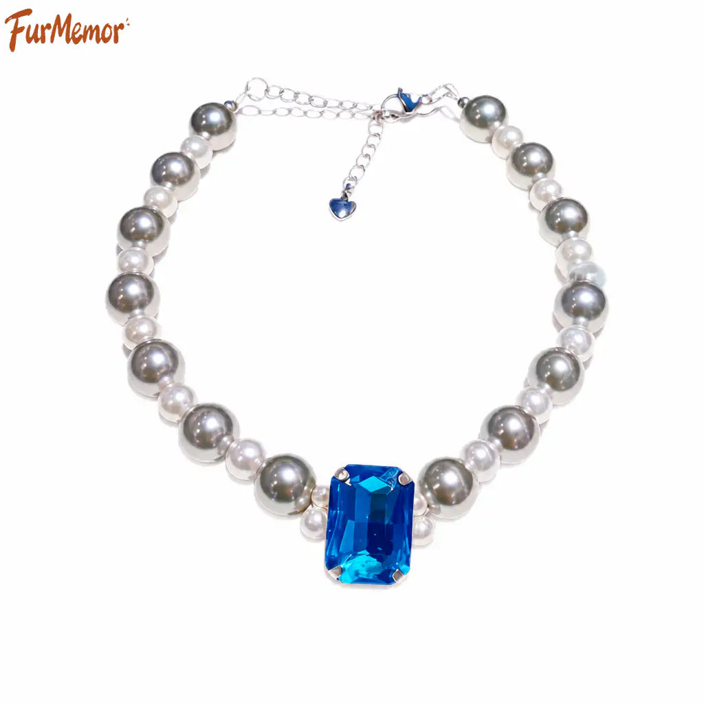 Close-up of crystal charm and pearl details on pet necklace